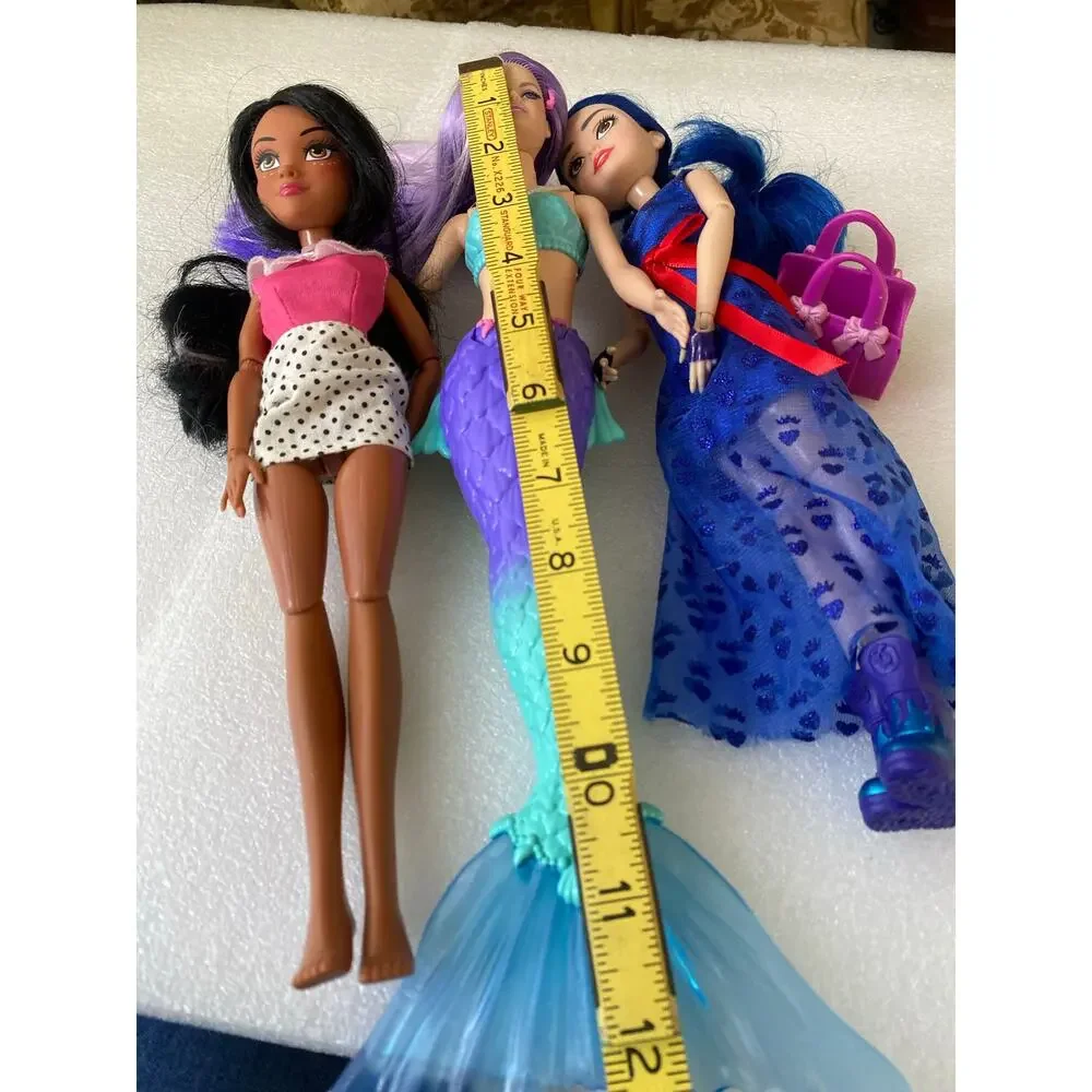 three dolls Barbie Dreamtopia Mermaid Doll with purple hair and purple-and blue